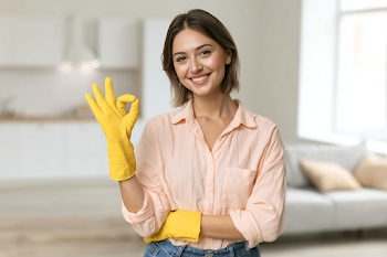 Cheerful Young Woman in Cleaning Gloves