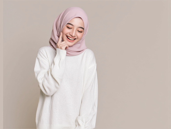 Cheerful Young Woman in Pink Hijab and White Sweater