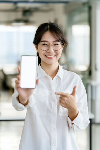 Confident Young Asian Businesswoman Showcasing Smartphone