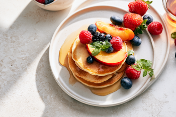 Delicious Summer Breakfast with Fluffy Pancakes and Fresh Fruits