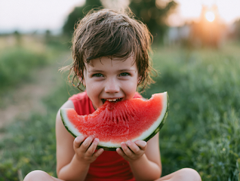 Joyful Child Enjoying Watermelon in Summer