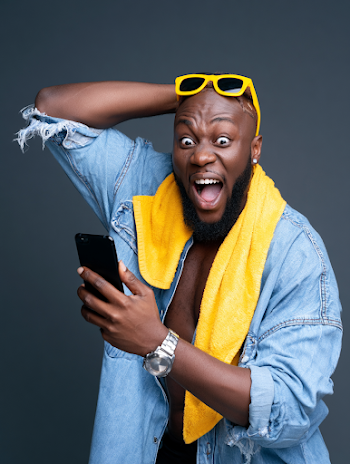 Joyful Young Black Man Excited with Smartphone