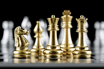 Luxury Gold Chess Pieces on Glossy Board