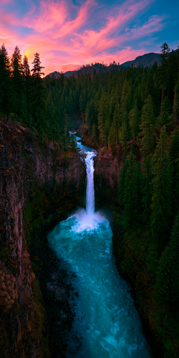 Majestic Waterfall Cascading into Turquoise River
