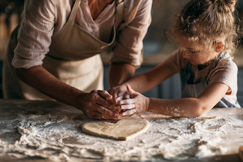 Mother and Child Baking Heart Cookies in a Cozy Kitchen