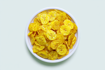 Overhead View of Crispy Banana Chips in a White Bowl
