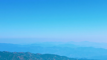 Serene Layered Mountain Landscape Under Clear Blue Sky