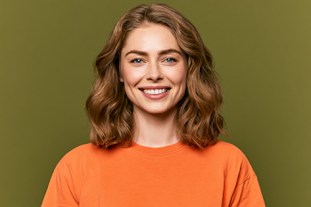 Smiling Young Woman in Bright Orange T-Shirt