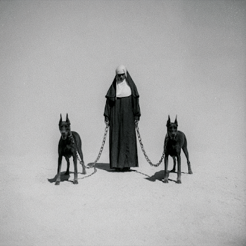 Stern Nun with Aggressive Doberman Pinschers in Minimalist Void