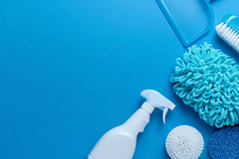 Vivid Cleaning Supplies Arrangement on Cyan Surface