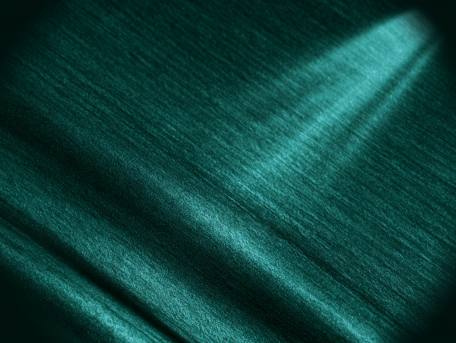 Abstract Close-Up of Dark Teal Fabric Texture with Turquoise Light