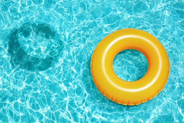 Bright Yellow Inflatable Swim Ring in Turquoise Pool