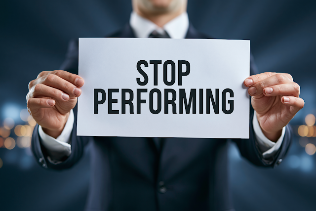 Businessman Holding 'Stop Performing' Sign