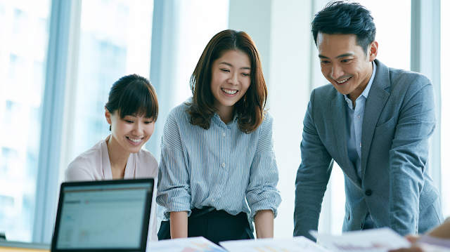 Confident Asian Professionals Analyzing Growth Charts in Modern Office