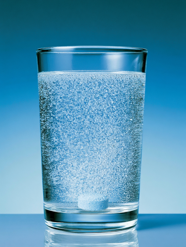 Effervescent Tablet in Clear Glass of Water