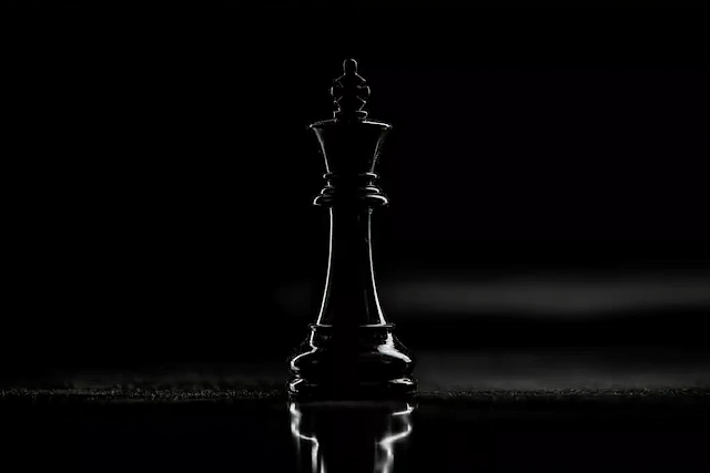 Elegant Black Chess King on Reflective Surface