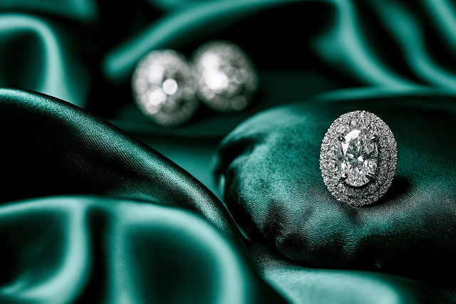 Elegant Oval Diamond Stud Earrings on Emerald Silk