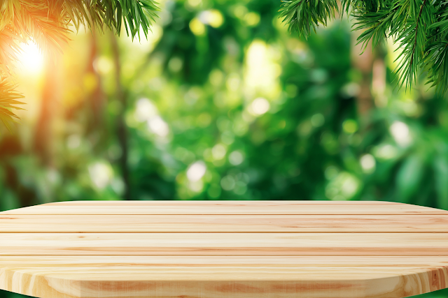 Empty Light Wooden Tabletop in Lush Tropical Garden