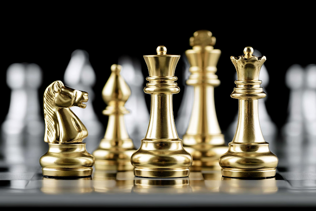Luxury Gold Chess Pieces on Glossy Board