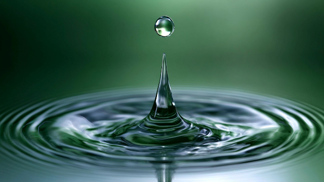 Macro Water Droplet Splash Over Calm Surface
