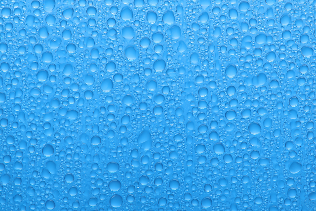 Macro Water Droplets on Blue Glass Surface