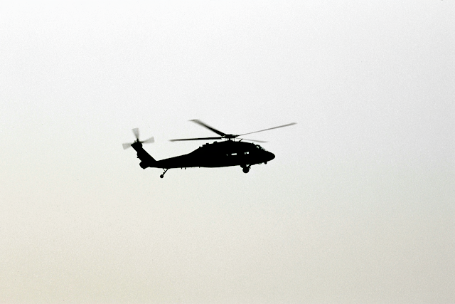 Silhouette of Helicopter in Minimalist Sky