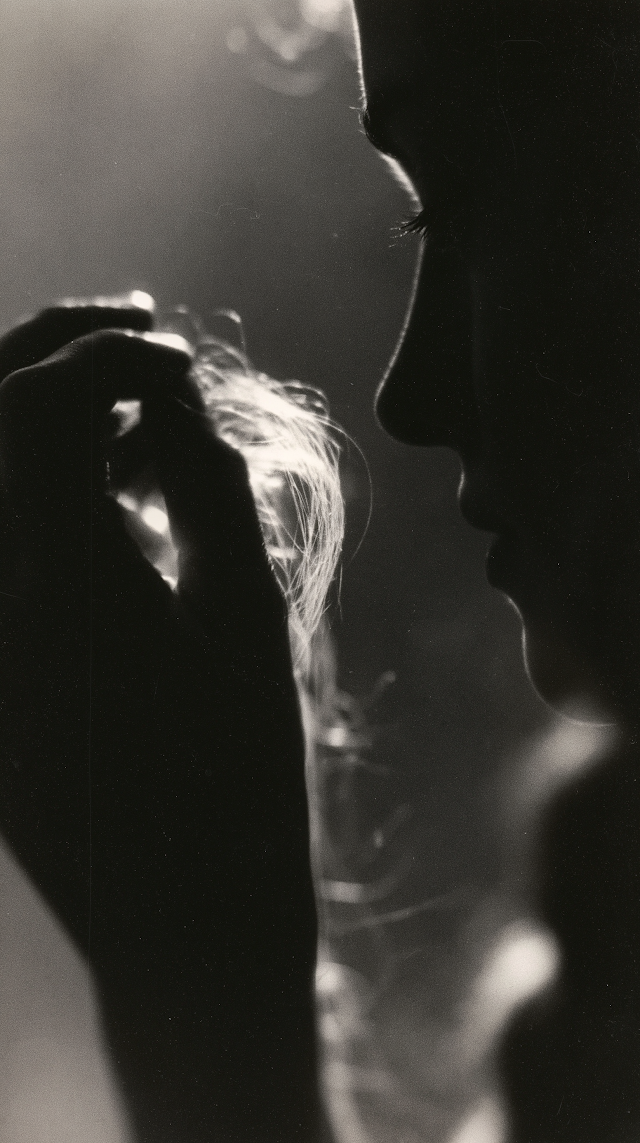 Silhouetted Hand Holding Hair in Ethereal Black and White