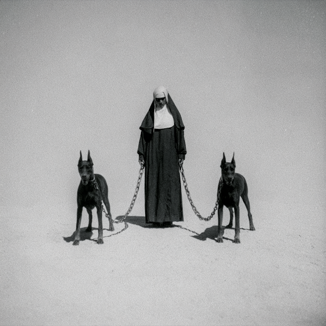 Stern Nun with Aggressive Doberman Pinschers in Minimalist Void