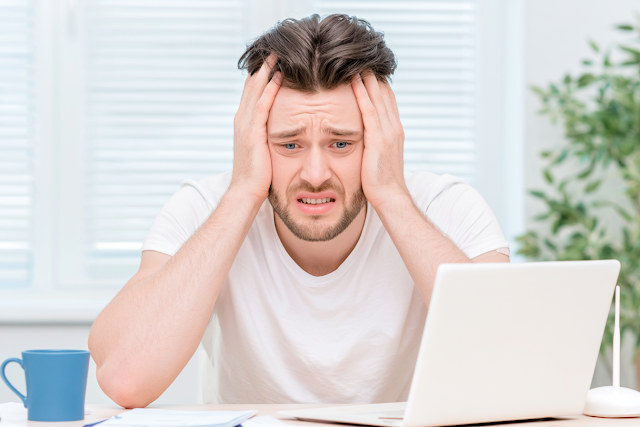 Stressed Young Man in Modern Home Office