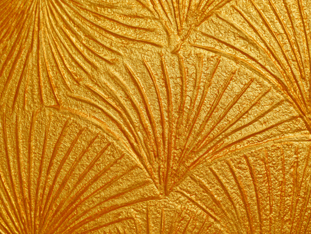 Textured Golden Wall Panel with Abstract Palm Leaf Patterns
